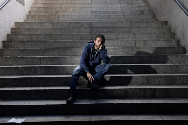 Young man lost in depression sitting on ground street concrete stairs — Stock Photo, Image