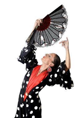 Spanish woman dancing Sevillanas wearing fan and typical folk black with white dots dress clipart