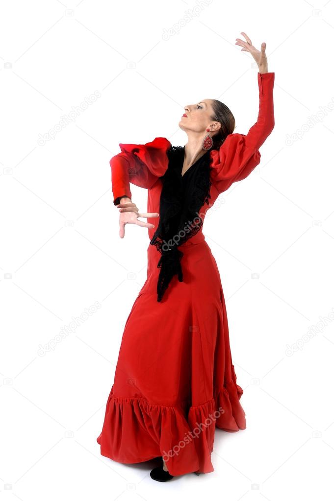young spanish woman dancing flamenco in typical folk red dress