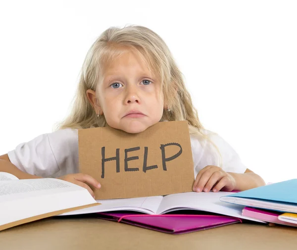 Sweet little school girl holding help sign in stress with books and homework — Stock Photo, Image