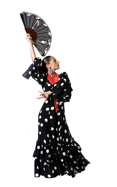 Mujer española joven bailando Sevillanas con abanico y típico folklore negro con vestido de lunares blancos — Foto de Stock