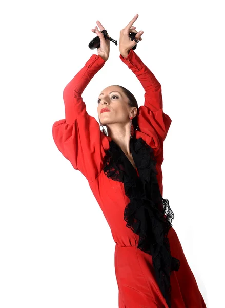 Молодая испанка танцует фламенко с кастаньетами в руках — стоковое фото