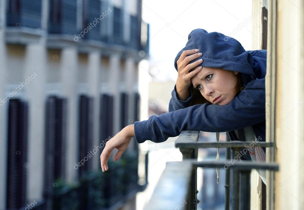  woman suffering depression and stress outdoors at the balcony