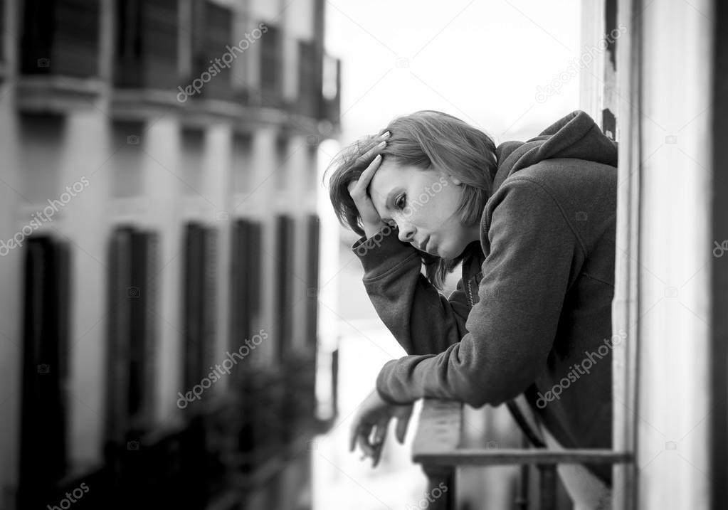 young woman suffering depression and stress outdoors at the balcony