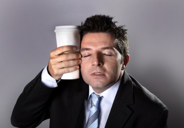 sleepy addict businessman holding take away coffee in caffeine addiction clipart