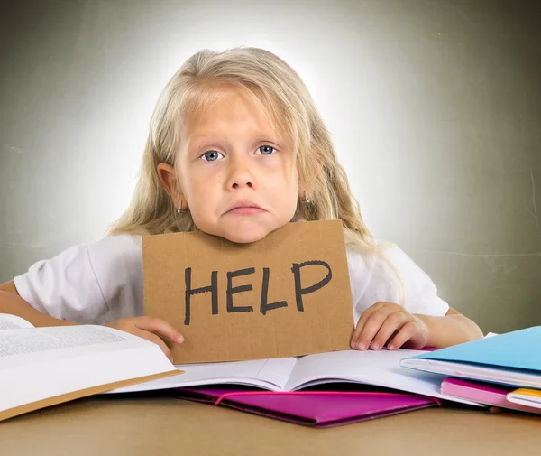 Sweet little school girl holding help sign in stress with books — Stock Photo, Image