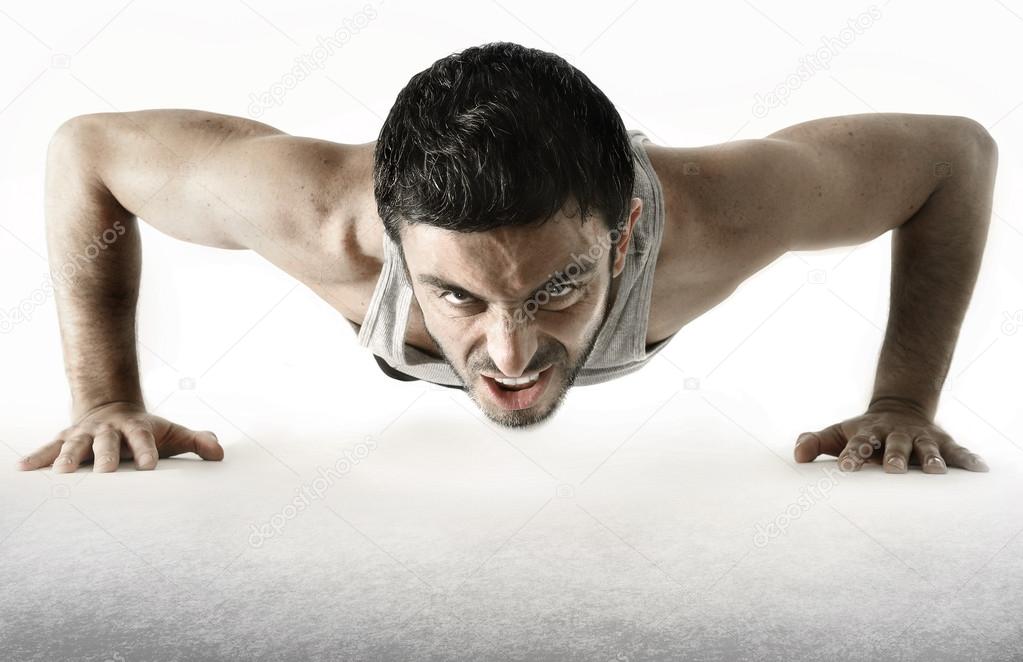 Attractive sport man training push up exercise isolated on white