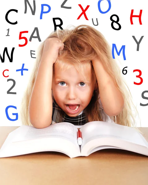 Sweet little schoolgirl pulling her blonde hair in stress with numbers and letters — Stock Photo, Image