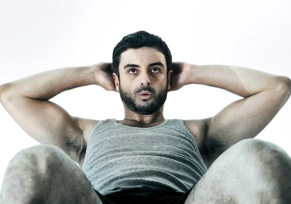 Attractive Latin sport man wearing running clothes doing sit up — Stock Photo, Image