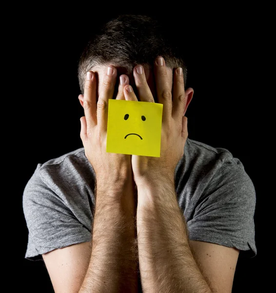 Jonge man die lijden aan depressie en stress alleen met droevig gezicht post-it note — Stockfoto