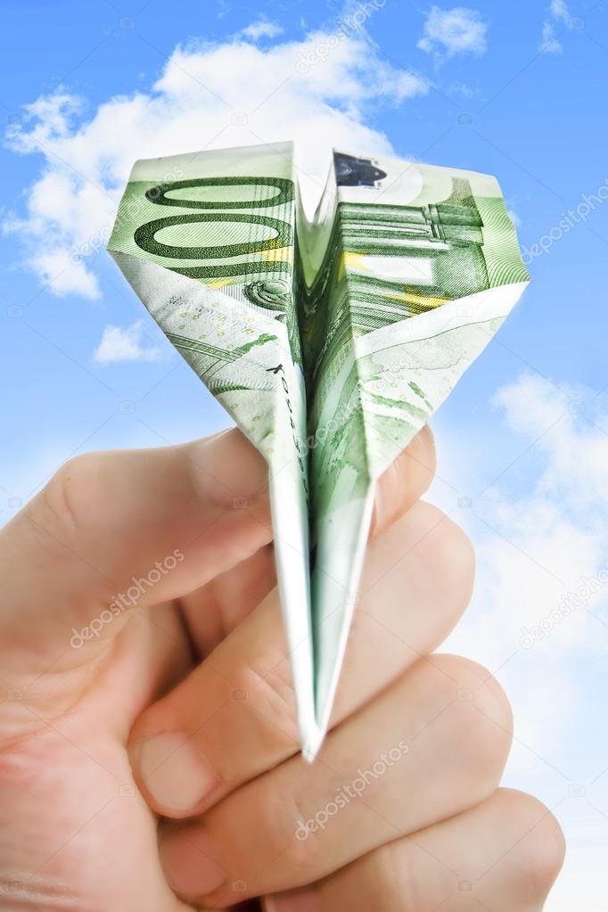Hand Holding Banknote Paper Plane In Making Money And Financial - hand holding banknote paper plane in making money and financial stock photo