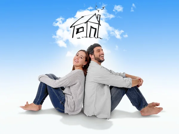 Young couple dreaming and imaging their new house in real state — Stock Photo, Image