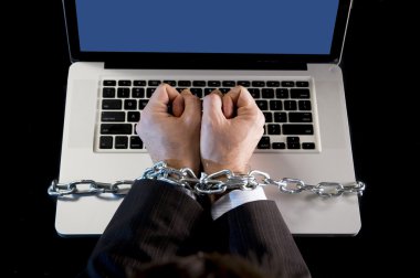 Hands of businessman addicted to work bond with chain to computer laptop in workaholic clipart