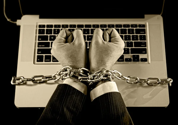 Hands of businessman addicted to work bond with chain to computer laptop in workaholic — Stock Photo, Image