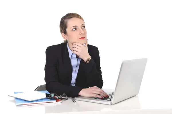 Attractive businesswoman thinking and looking distraught while working on computer — Stock Photo, Image