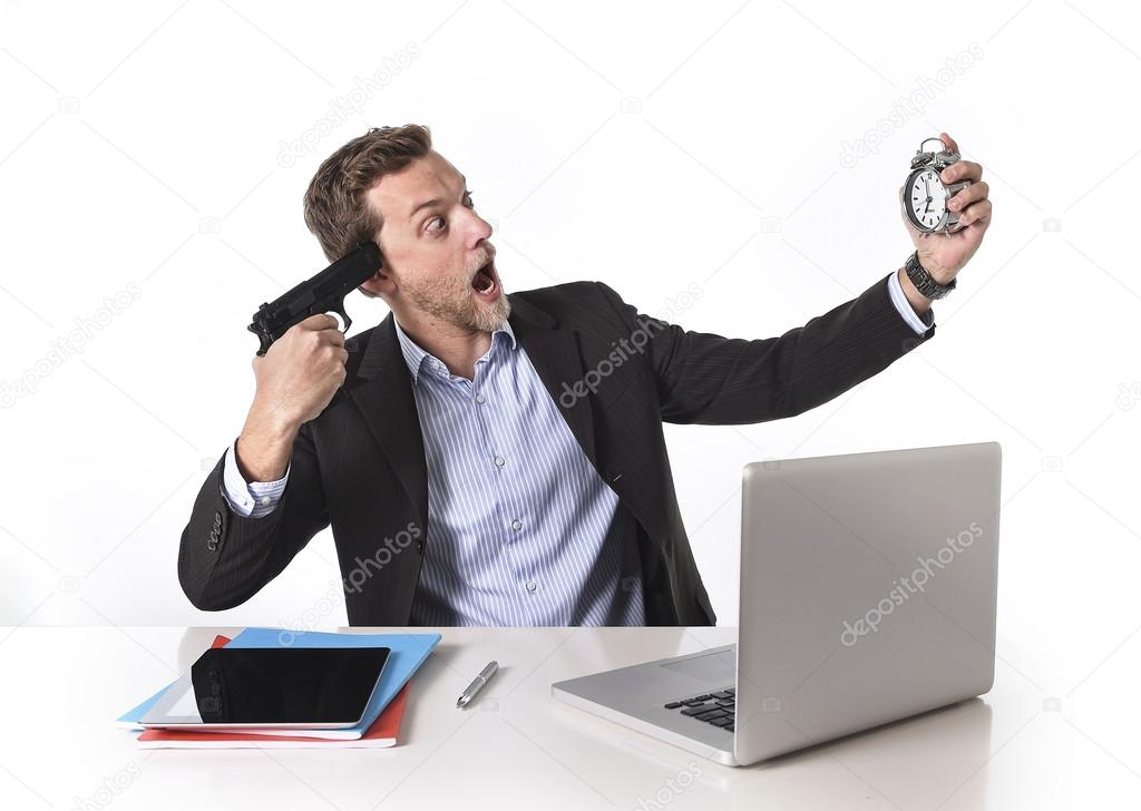 Businessman pointing gun to head holding watch in overwork and overtime work concept