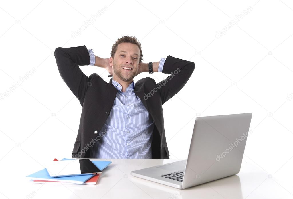 attractive businessman happy at work smiling relaxed at computer desk