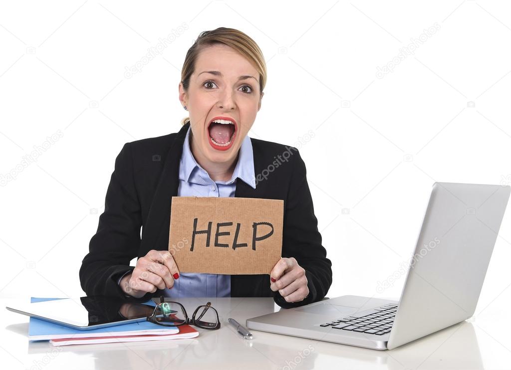 Young stressed businesswoman holding help sign overworked at office computer