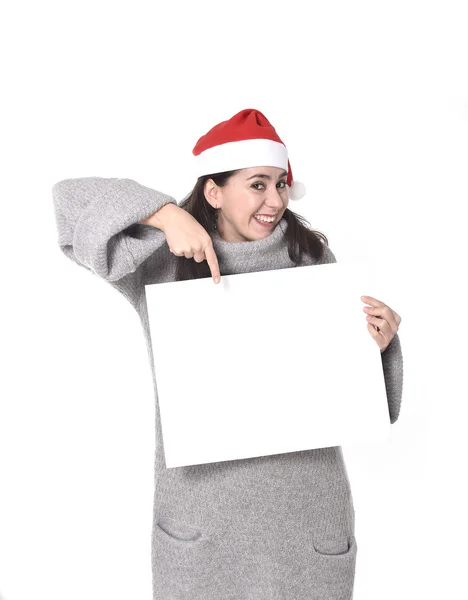 Jovem doce mulher latina em Santa chapéu de Natal apontando outdoor em branco — Fotografia de Stock