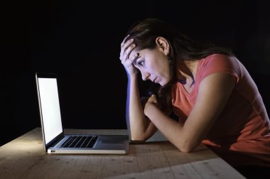  depressed worker or student woman working with computer alone late night in stress 