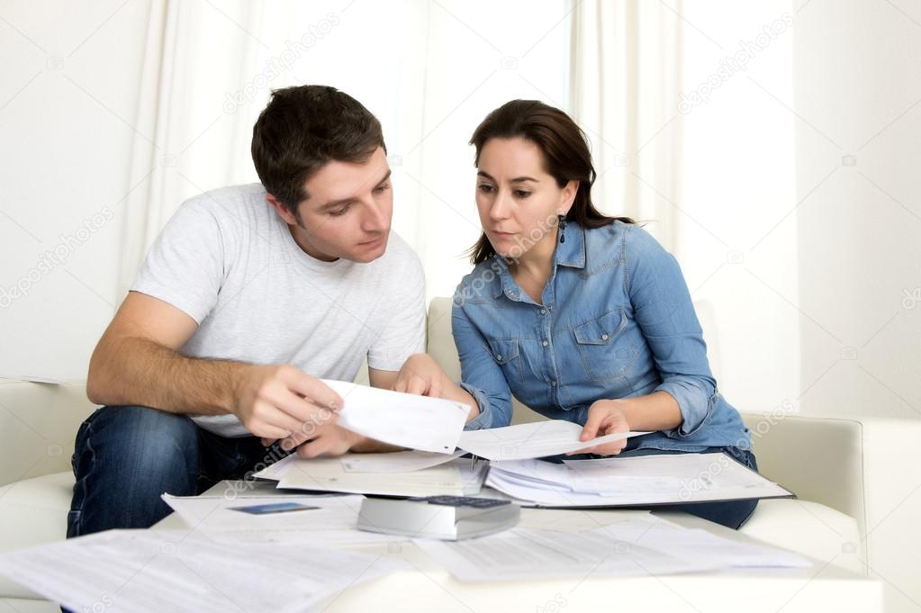 young couple worried at home in stress accounting bank payments 