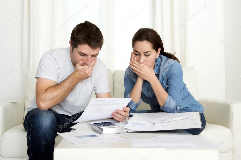 young couple worried at home in stress accounting bank payments 
