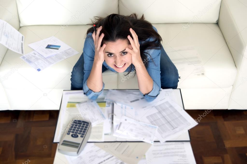 young woman worried at home in stress accounting desperate in financial problems