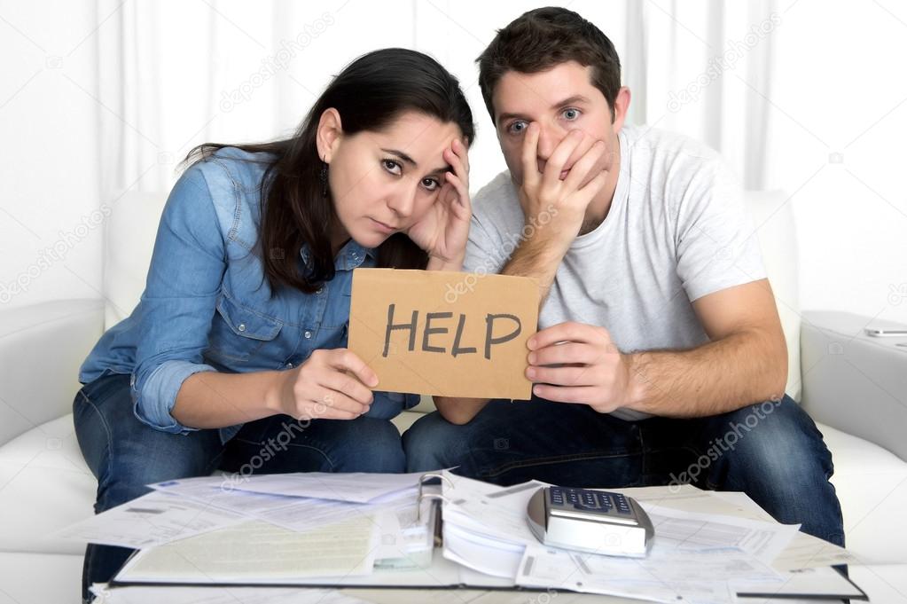 Young couple worried at home in bad financial situation stress