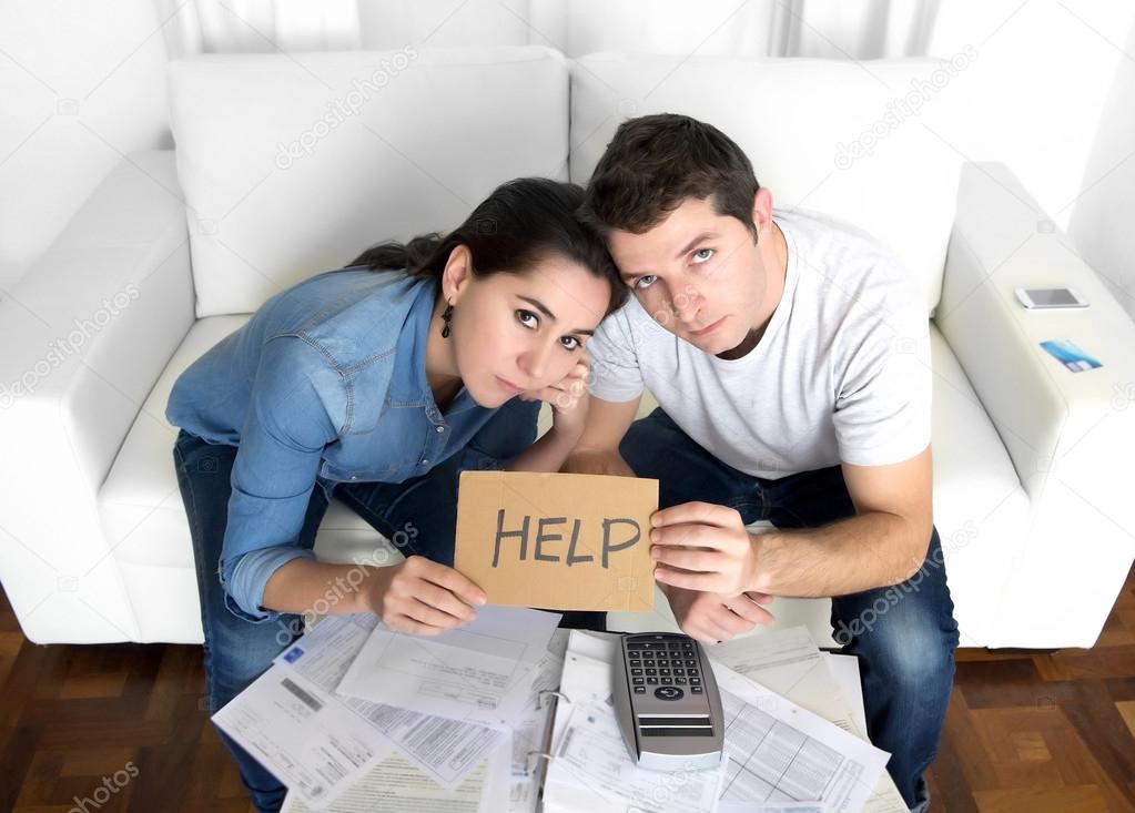 Young couple worried at home in bad financial situation stress