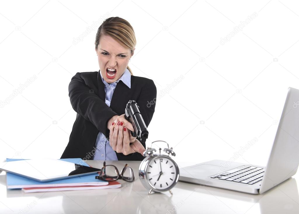 furious angry businesswoman working pointing gun to alarm clock in out of time concept