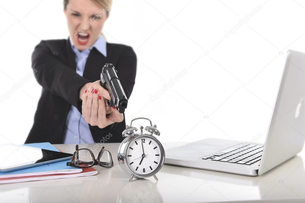 furious angry businesswoman working pointing gun to alarm clock in out of time concept