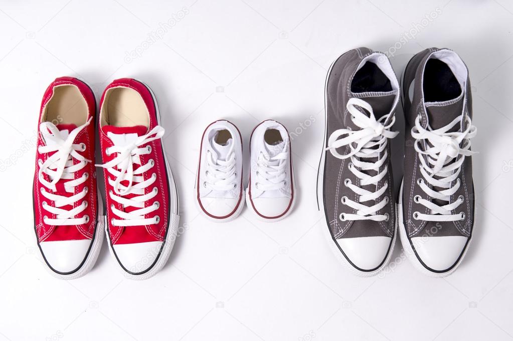 shoes in father big, mother medium and son or daughter small kid size in family love concept