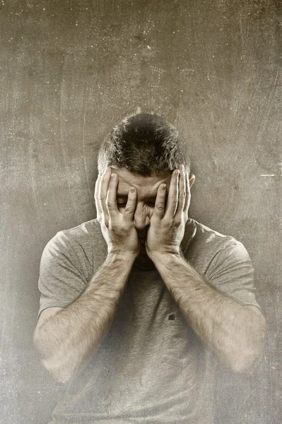 Man suffering depression, headache ,migraine and pain covering face with hands — Stock Photo, Image