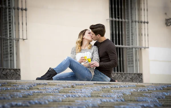 Young beautiful couple in love on street together celebrating Valentines day with Champagne toast — Stock Photo, Image