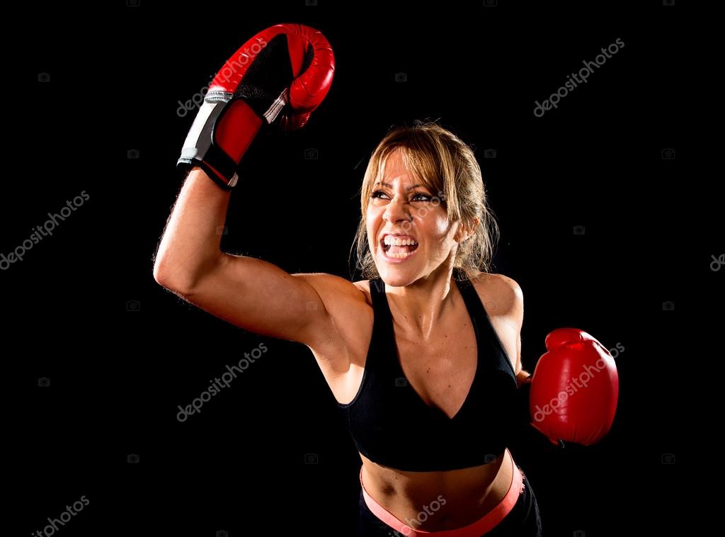 Young fit and strong attractive boxer girl with red boxing gloves