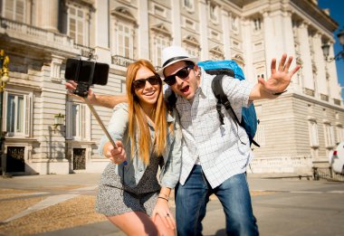 beautiful friends tourist couple visiting Spain in holidays students exchange taking selfie picture