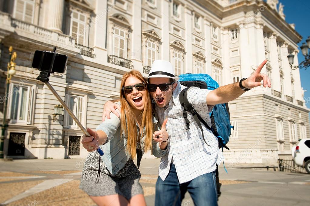 beautiful friends tourist couple visiting Spain in holidays students exchange taking selfie picture