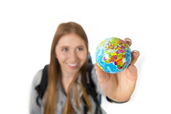 Beautiful student girl holding little world globe in her hand choosing holidays destination in travel tourism concept — Stock Photo, Image