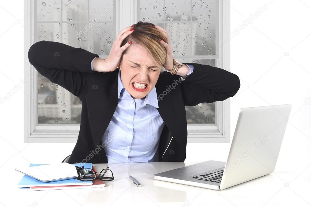 young businesswoman angry in stress at office working on computer