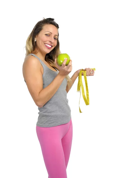 Sexy beautiful woman holding green apple fruit and measure tape — Stock Photo, Image