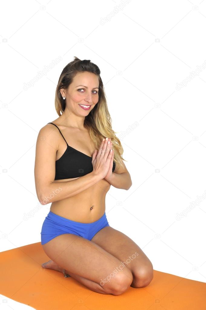 Young sexy attractive fit woman at gym doing yoga exercise and