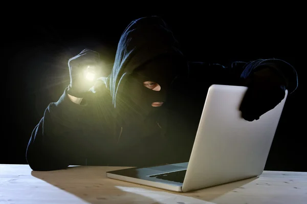 Expert hacker with computer laptop holding flashlight hacking system — Stock Photo, Image