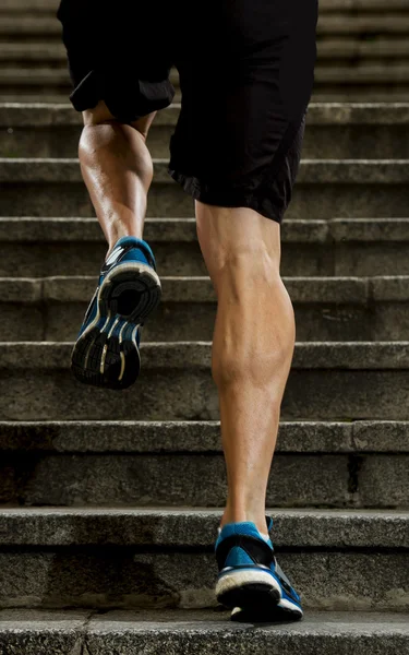 Young athletic legs with sharp scarf muscles of runner sport man climbing up city stairs jogging and running in urban training workout — Stock Photo, Image