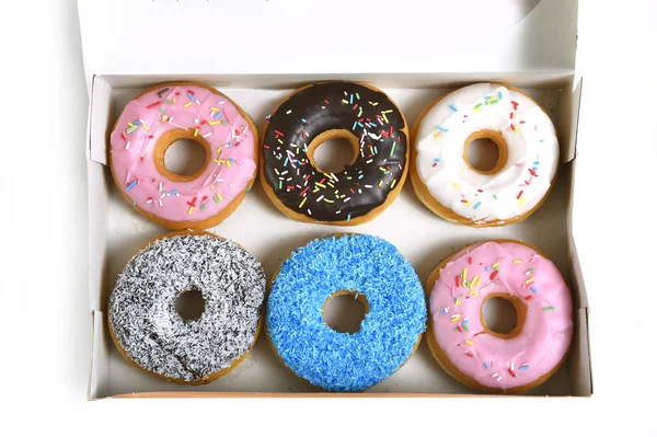 Delicious and tempting box full of donuts with different flavours and toppings sugar addiction concept — Stock Photo, Image