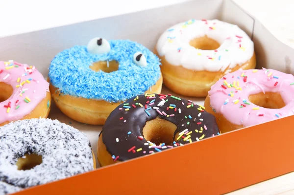 Delicious and tempting box full of donuts with different flavours and toppings sugar addiction concept — Stock Photo, Image