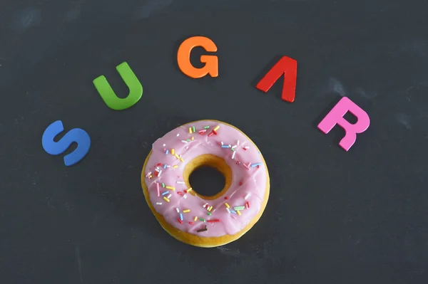 Delicious tempting donut with toppings unhealthy nutrition sugar addiction concept — Stock Photo, Image