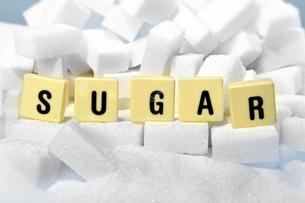 sugar block letters word on pile of sugar cubes close up in addiction concept