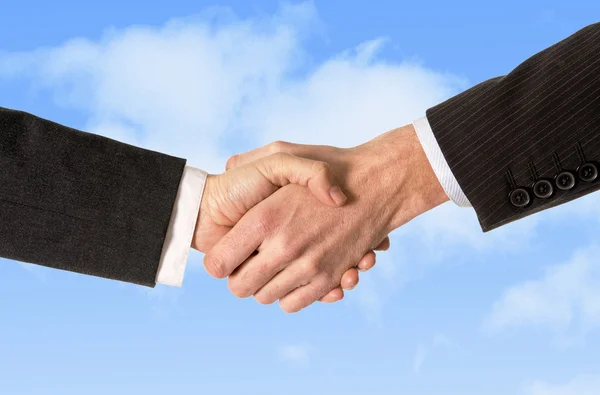 Close up of business man shaking hands with woman isolated on blue sky background — Stock Photo, Image