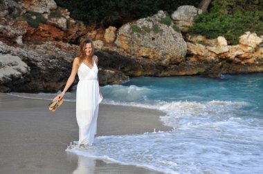 attractive and beautiful woman enjoying vacation summer holidays at Spain coast village walking on beach