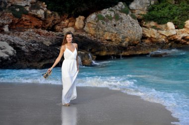 attractive and beautiful woman enjoying vacation summer holidays at Spain coast village walking on beach